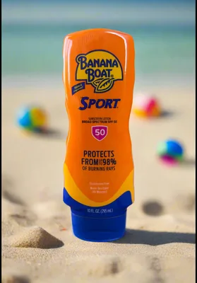 Banana Boat Sport sunscreen bottle standing in beach sand